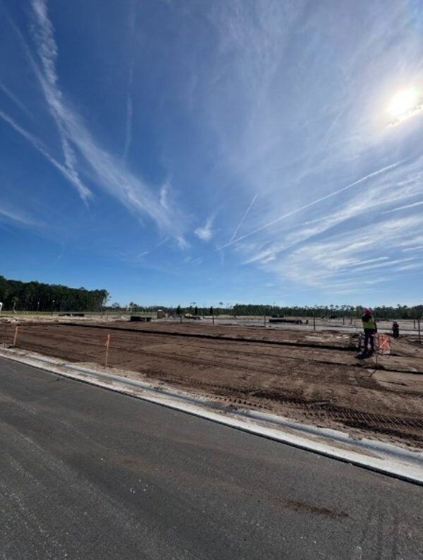 Commercial subdivision pad preparation with completed grading and curb work in Northeast Florida