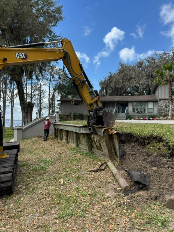 Old failing wooden retaining wall being demolished on a St. Johns River waterfront property