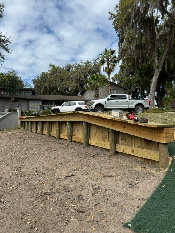 New wooden retaining wall built with treated lumber and proper structural support on St. Johns River waterfront